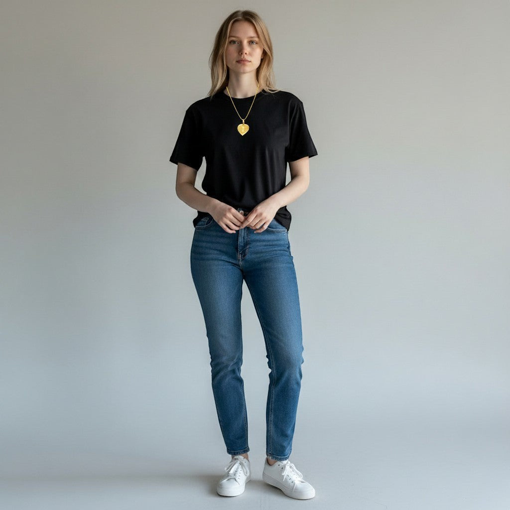 Model wearing a Royal Dubai Jewellers 22K solid gold letter pendant on a simple chain against a grey background.